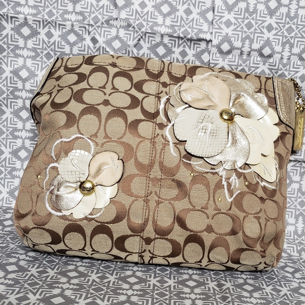 Coach brown logo handbag with flower decor.